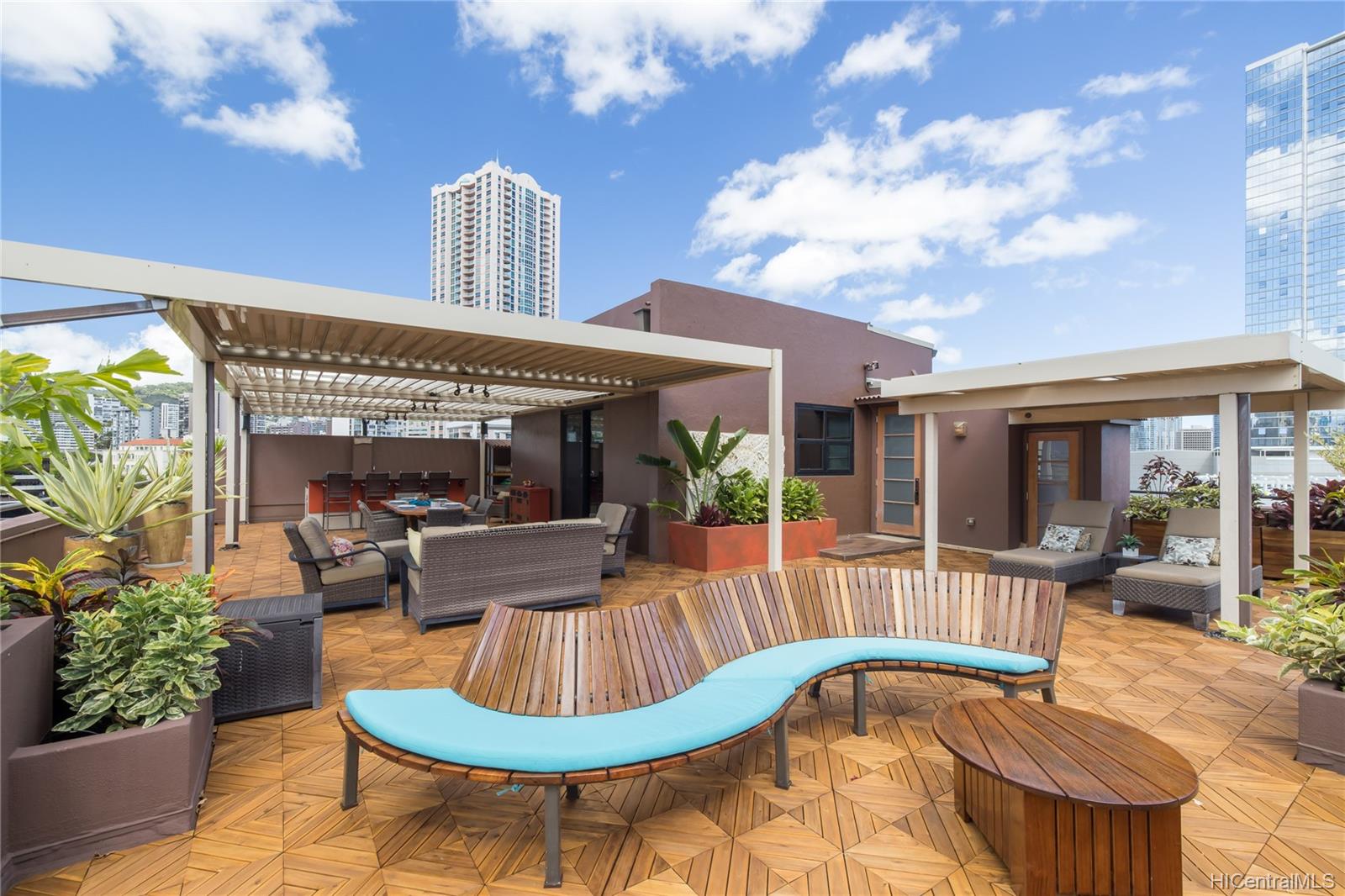 A private lanai with a beautiful view of the city in the Vanguard Lofts 501 in Hawaii.